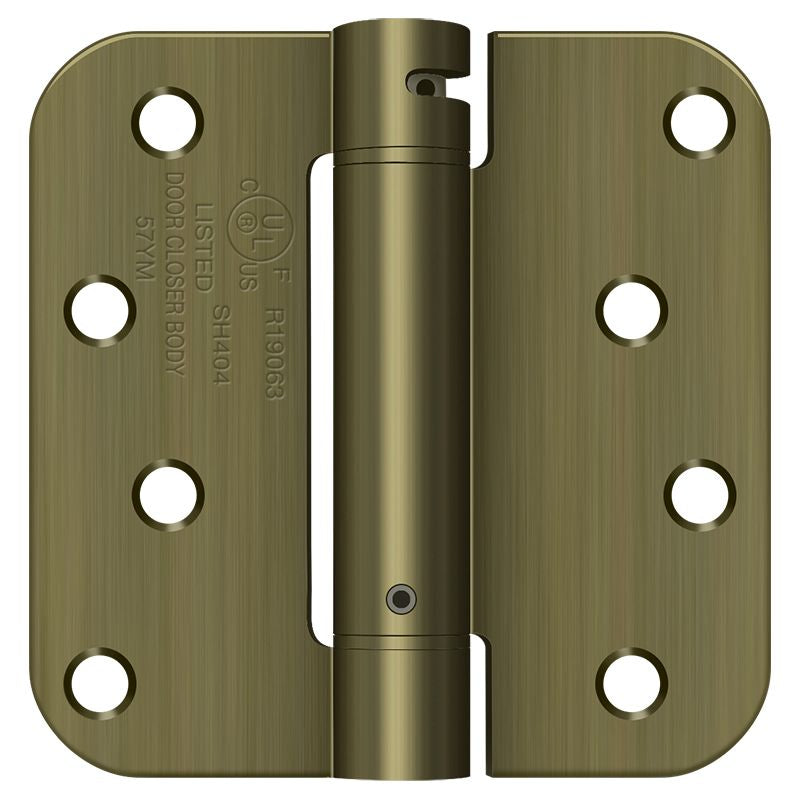 Deltana DSH4R55 4" x 4" 5/8" Radius Spring Hinge; Antique Brass Finish Main image